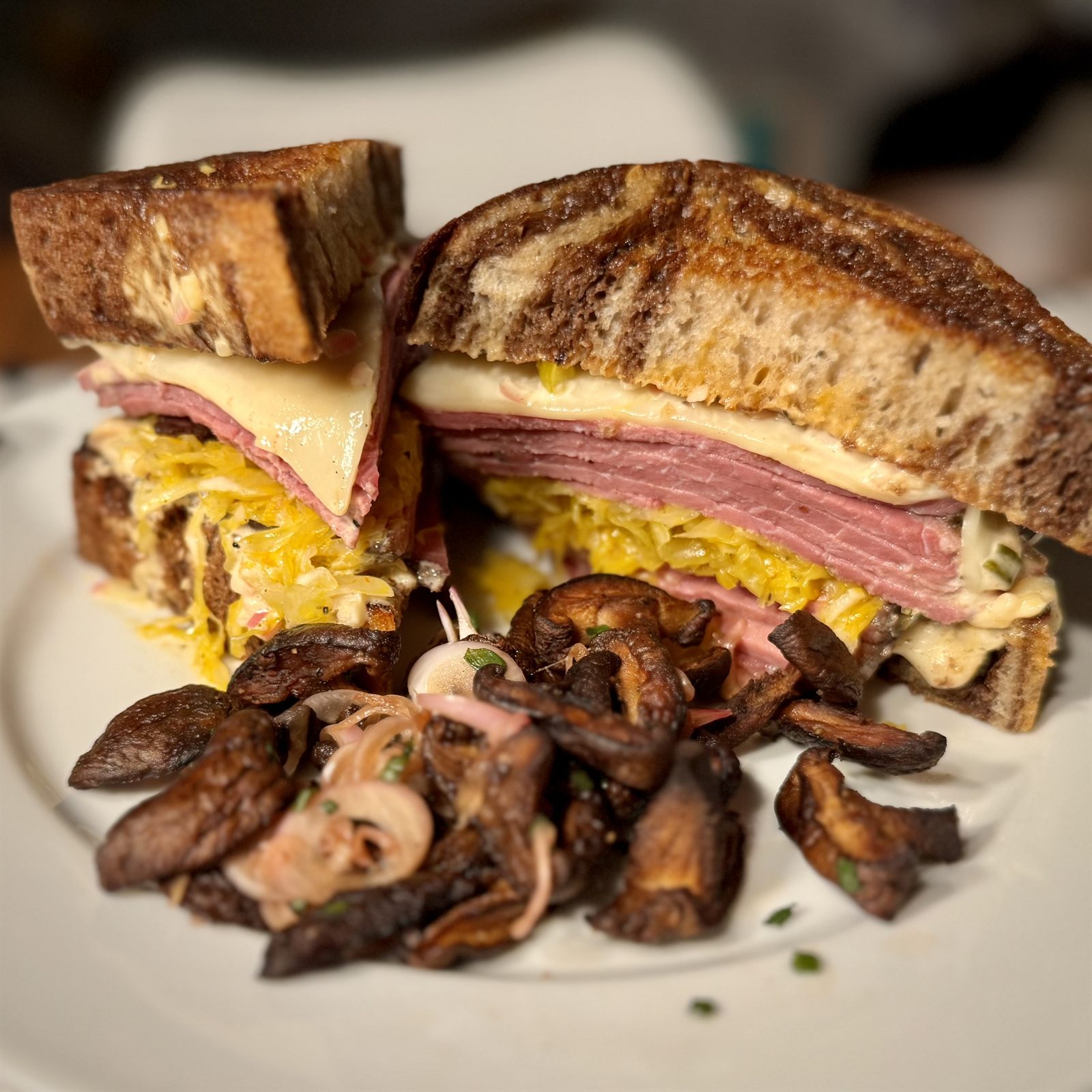 Pastrami and cheese sandwich on toasted rye with sautéed mushrooms